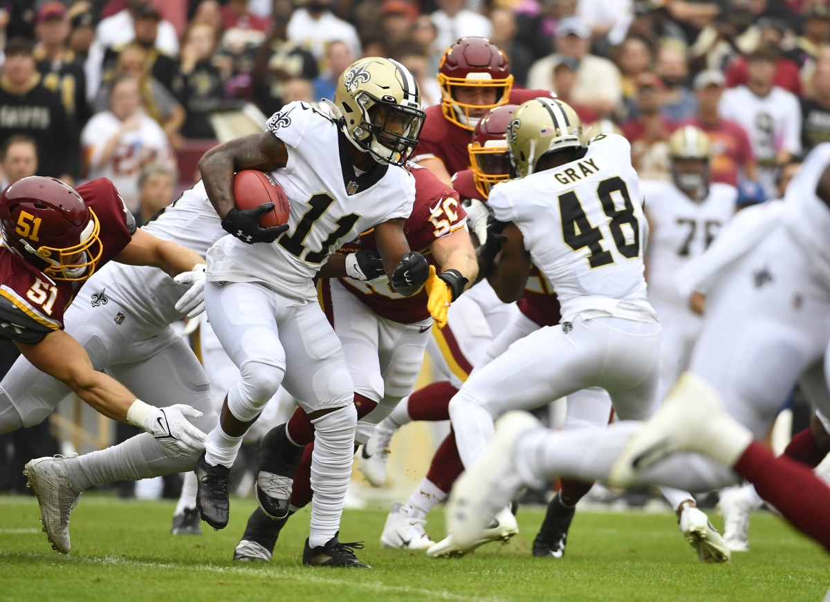 New Orleans Saints wide receiver Deonte Harris (11) returns a kick against Washington. Mandatory Credit: Brad Mills-USA TODAY 